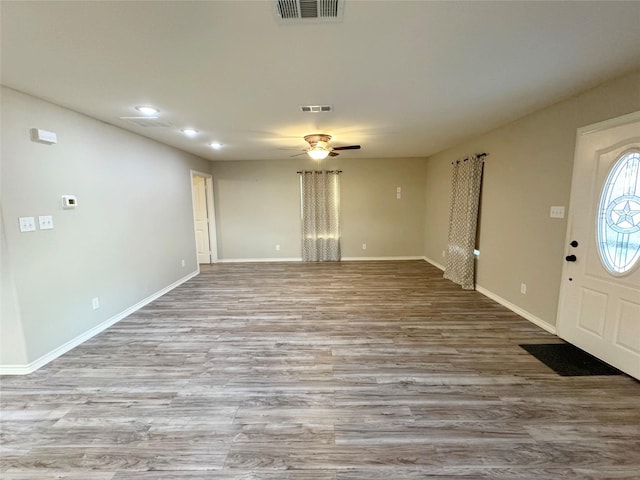 foyer featuring a ceiling fan, visible vents, and wood finished floors