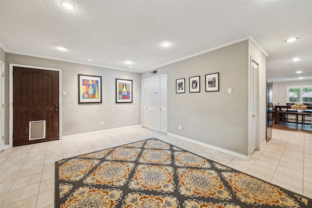 12312 Cox Ln, Dallas, TX 75244 - foyer with tile patterned flooring, a textured ceiling, recessed lighting, crown molding, and baseboards