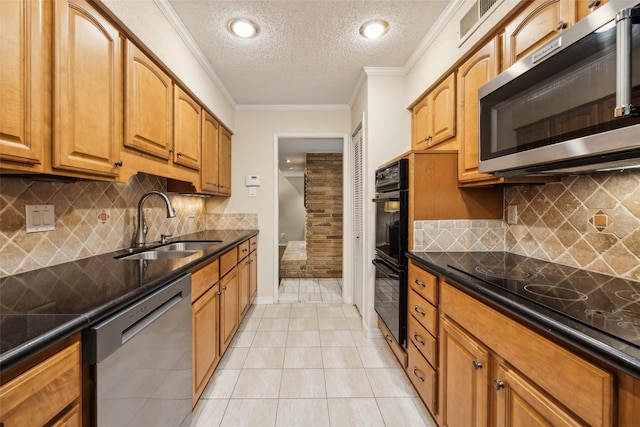 12312 Cox Ln, Dallas, TX 75244 - kitchen featuring black appliances, a textured ceiling, a sink, crown molding, and light tile patterned floors