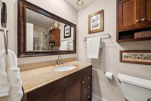 12312 Cox Ln, Dallas, TX 75244 - full bath featuring toilet, vanity, a shower, and baseboards