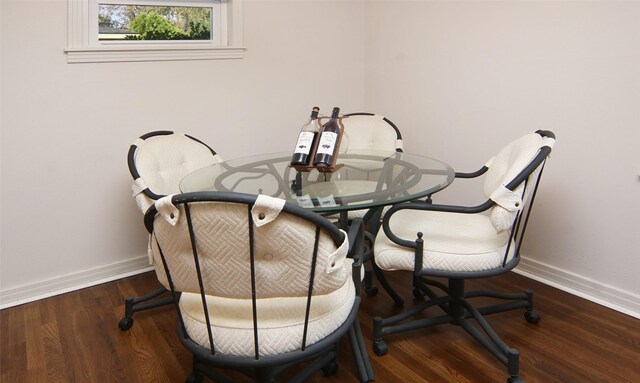 dining area with wood finished floors and baseboards