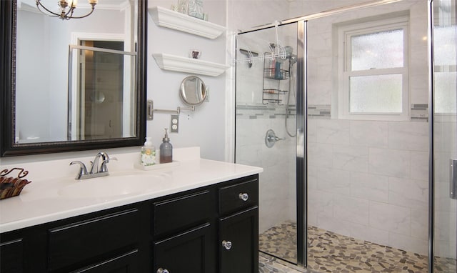 bathroom with a shower stall and vanity