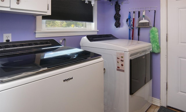 laundry area featuring baseboards, cabinet space, and independent washer and dryer