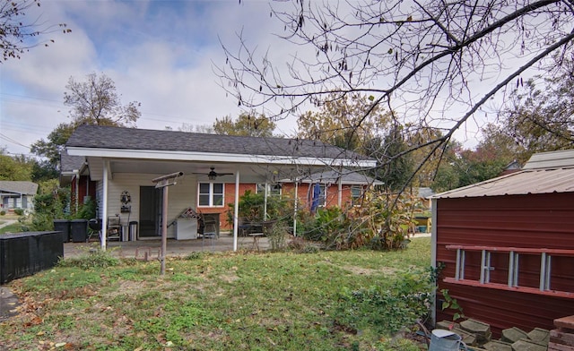 rear view of house with a ceiling fan and a patio area