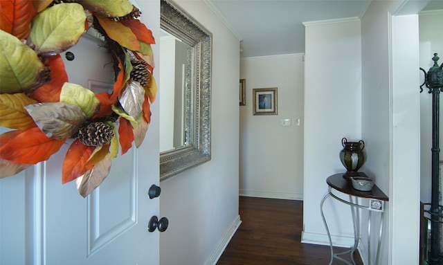 corridor featuring ornamental molding, wood finished floors, and baseboards