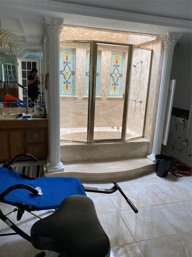 interior space featuring vanity, marble finish floor, and decorative columns