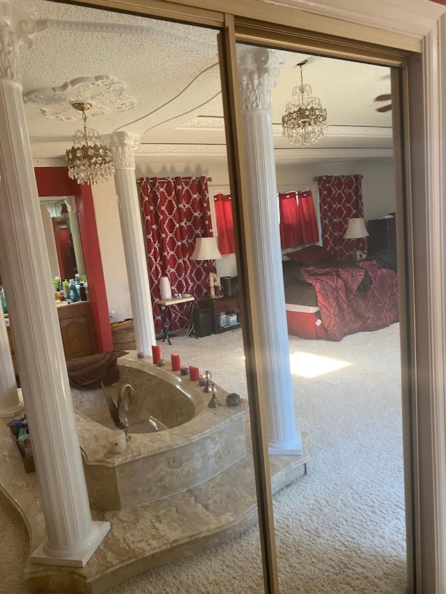 bathroom with an inviting chandelier and decorative columns