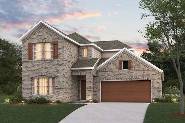 view of front of property featuring concrete driveway, a front yard, brick siding, and a garage