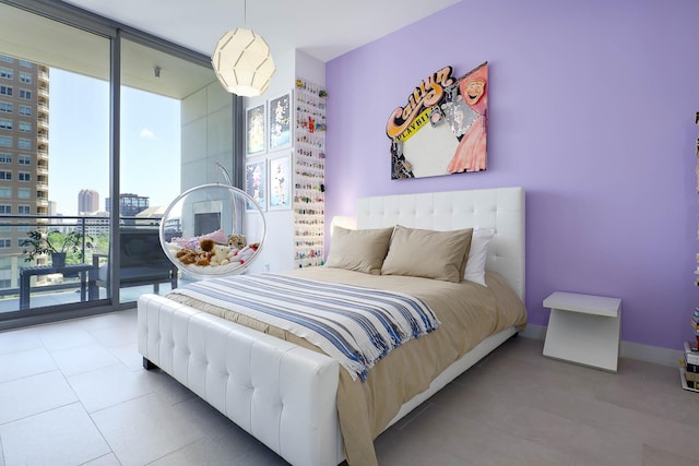 bedroom with tile patterned floors, access to outside, a wall of windows, and a city view