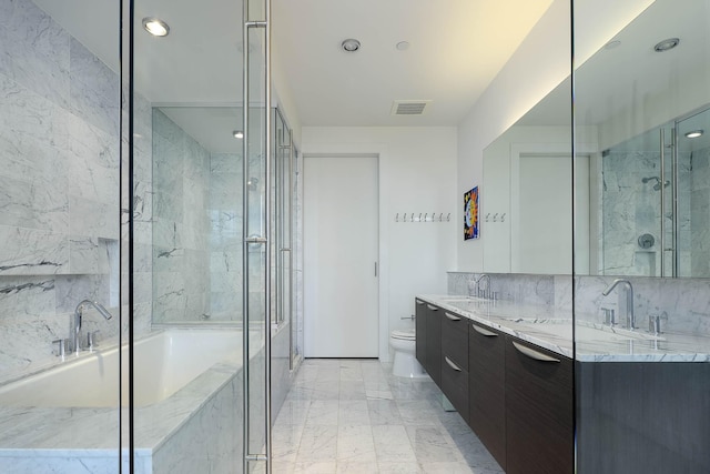 full bath with a shower stall, double vanity, marble finish floor, toilet, and a sink