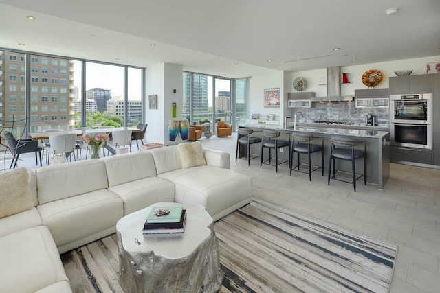 living area featuring a view of city, recessed lighting, and floor to ceiling windows
