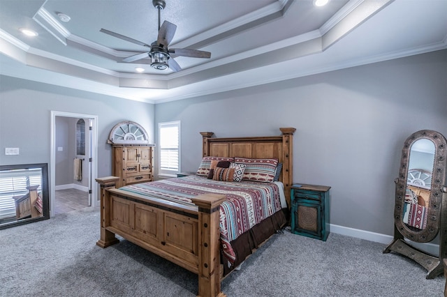 carpeted bedroom with ornamental molding, ceiling fan, baseboards, and a tray ceiling