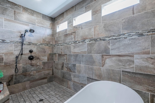 bathroom with a freestanding bath and tiled shower