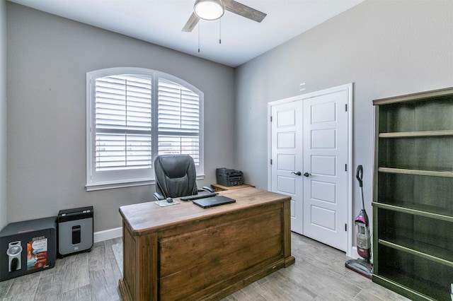 office space with a ceiling fan and light wood-style flooring