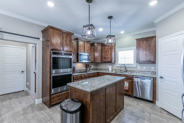 kitchen featuring light stone countertops, a sink, stainless steel appliances, a center island, and backsplash