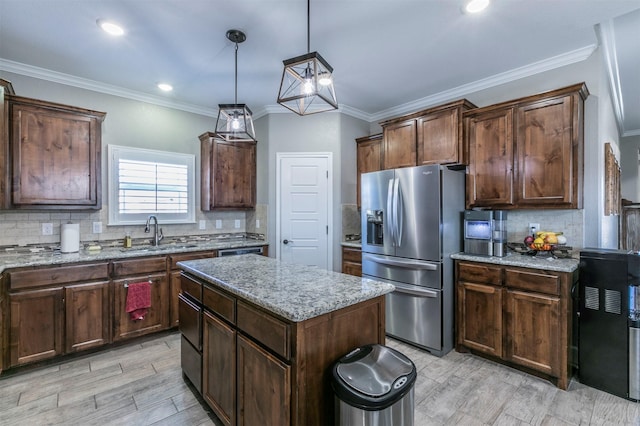 kitchen with light stone countertops, a sink, backsplash, and stainless steel fridge with ice dispenser