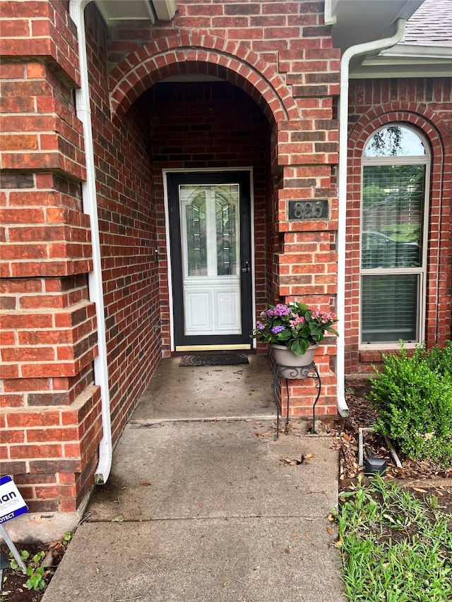entrance to property with brick siding