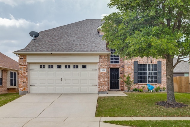 view of front of home with a front yard, driveway, roof with shingles, an attached garage, and fence