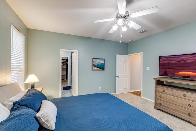 carpeted bedroom featuring baseboards, visible vents, ceiling fan, and a spacious closet