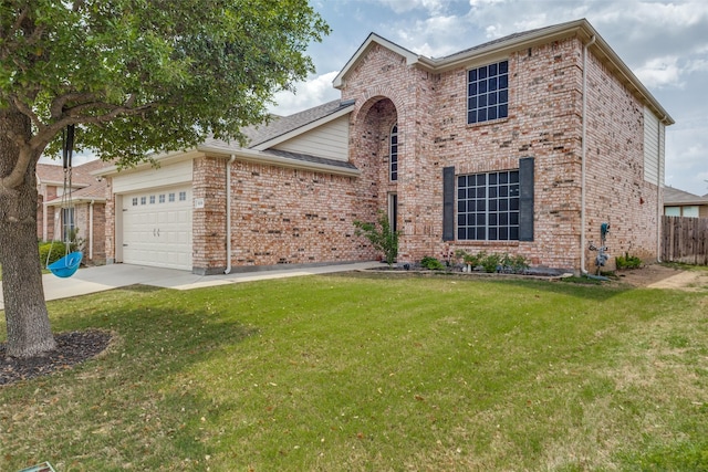 traditional home featuring driveway, an attached garage, a front yard, and brick siding