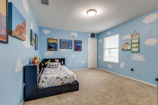 bedroom featuring carpet, visible vents, baseboards, and a textured ceiling