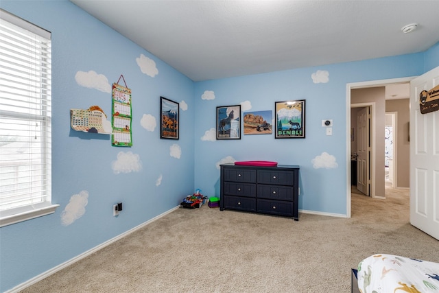 bedroom featuring baseboards and carpet