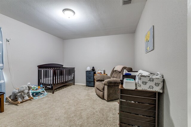 carpeted bedroom with visible vents and a crib
