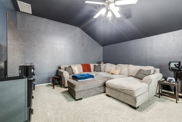 living room with ceiling fan, visible vents, a textured wall, vaulted ceiling, and light carpet