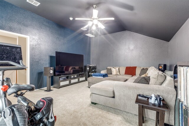 living area with ceiling fan, visible vents, a textured wall, vaulted ceiling, and carpet floors