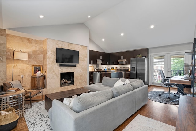 living area featuring recessed lighting, a premium fireplace, and light wood finished floors