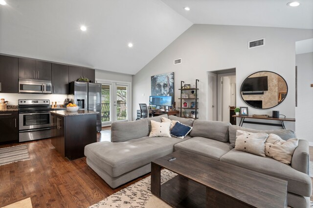 living room featuring visible vents, recessed lighting, dark wood-type flooring, and high vaulted ceiling