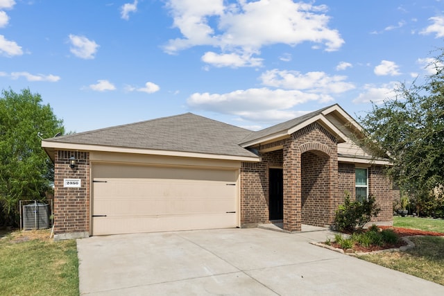 ranch-style house with concrete driveway, an attached garage, a shingled roof, and brick siding