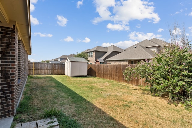 view of yard with a storage shed, a residential view, an outdoor structure, and a fenced backyard