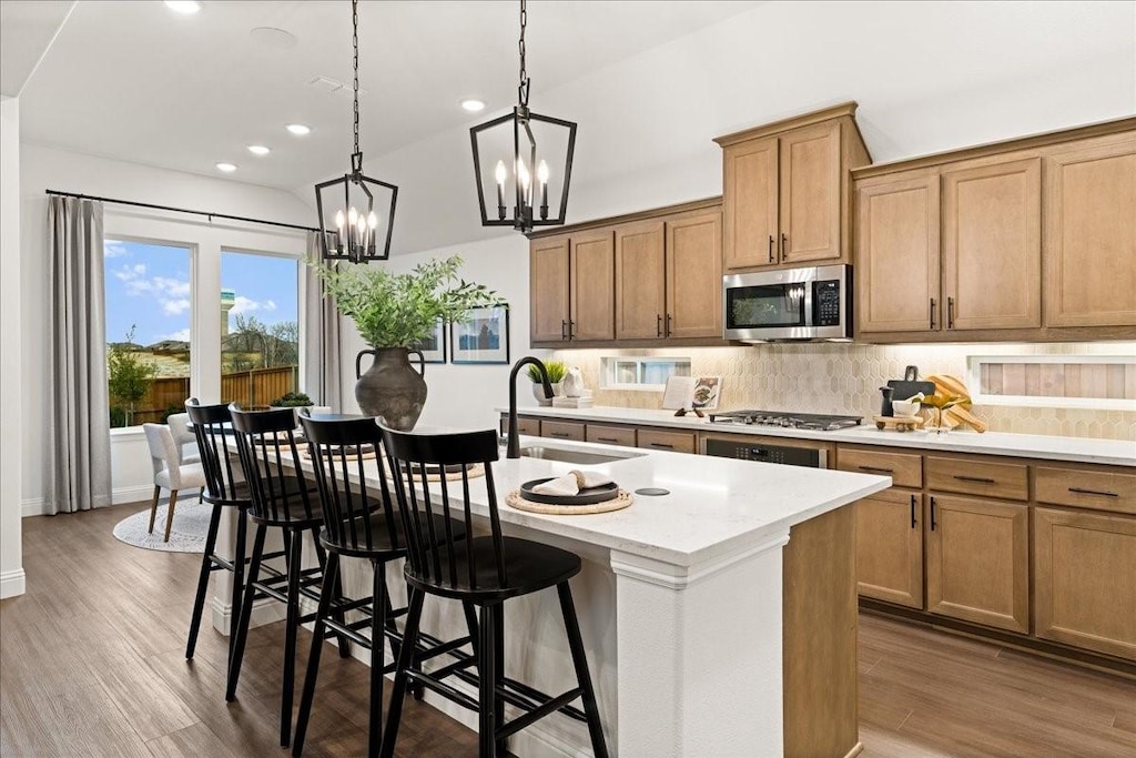 4047 Bedford, Crandall, TX 75114 - kitchen with a sink, appliances with stainless steel finishes, wood finished floors, and tasteful backsplash