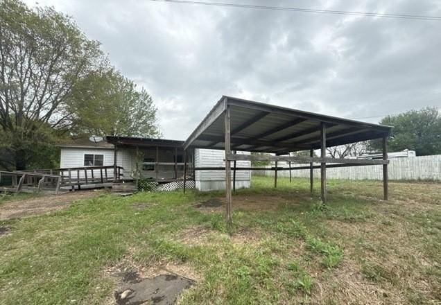 exterior space with a wooden deck and fence