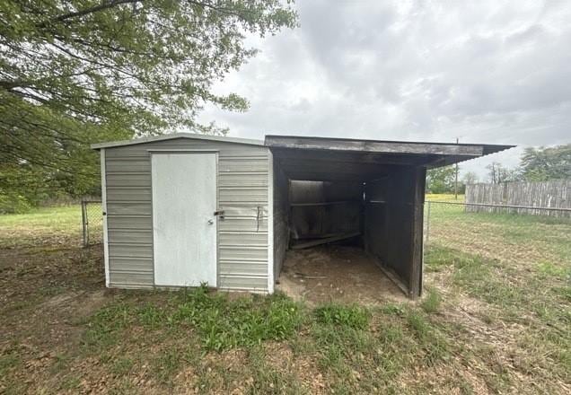 view of shed with fence