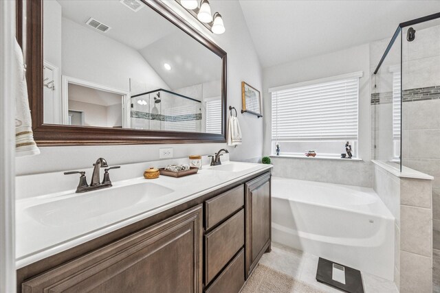 bathroom featuring a shower stall, vaulted ceiling, a bath, a sink, and visible vents