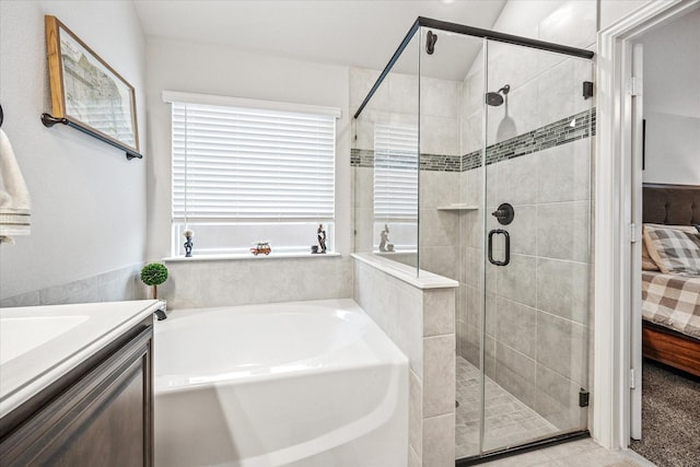 ensuite bathroom with ensuite bathroom, a bath, and a stall shower
