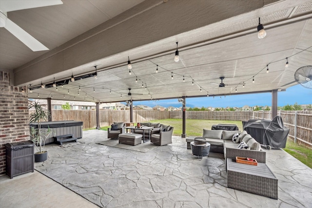 view of patio / terrace featuring an outdoor hangout area, ceiling fan, a fenced backyard, and a hot tub