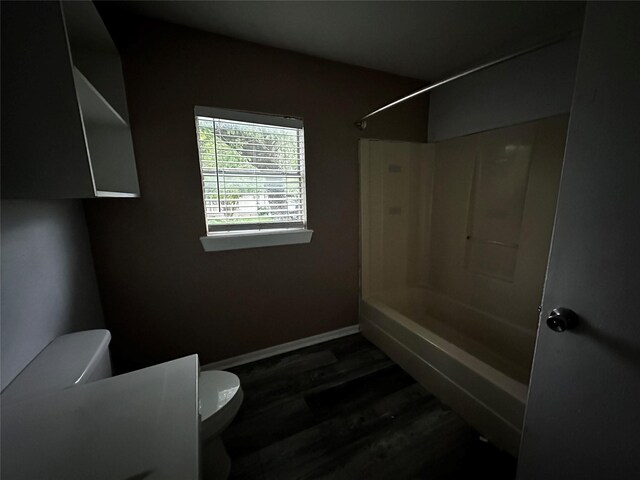 301 Lake Park Ave, Waxahachie, TX 75165 - full bath featuring baseboards, wood finished floors, toilet, and bathing tub / shower combination
