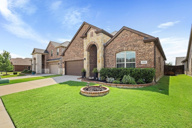3900 Fordham St, Frisco, TX 75036 - french country inspired facade featuring driveway, an attached garage, fence, brick siding, and a front lawn
