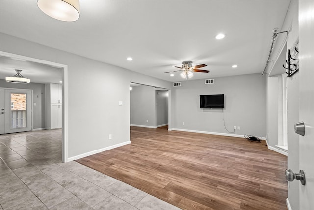 unfurnished living room featuring recessed lighting, a ceiling fan, and visible vents