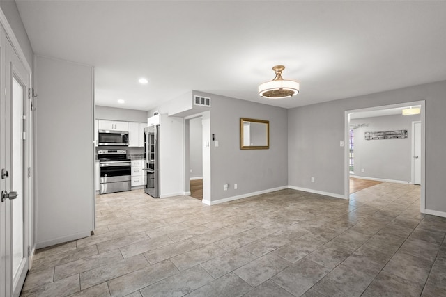 unfurnished living room with visible vents, recessed lighting, and baseboards
