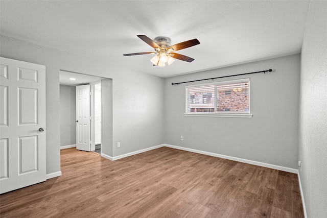unfurnished bedroom featuring a ceiling fan, wood finished floors, and baseboards