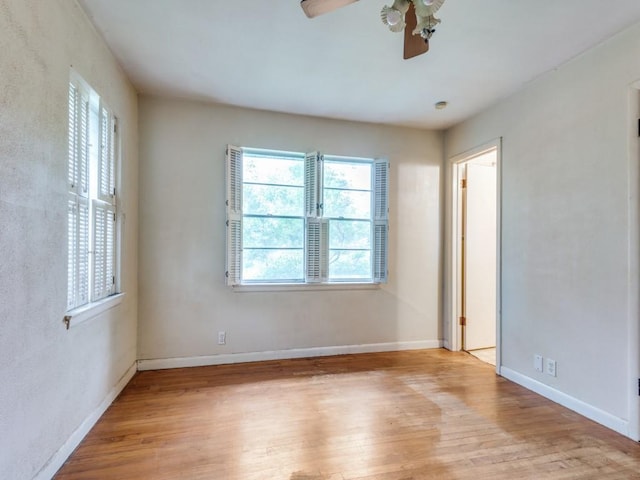1413 Sylvan Dr, Arlington, TX 76012 - unfurnished room with a healthy amount of sunlight, a ceiling fan, and wood finished floors