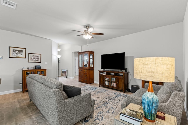 living area with wood finished floors, visible vents, ceiling fan, and baseboards