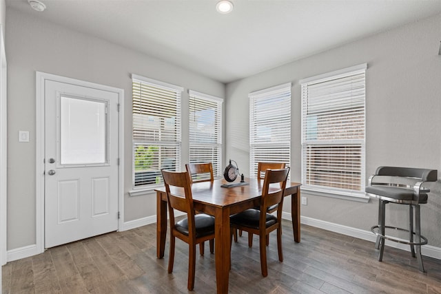dining area featuring wood finished floors and baseboards