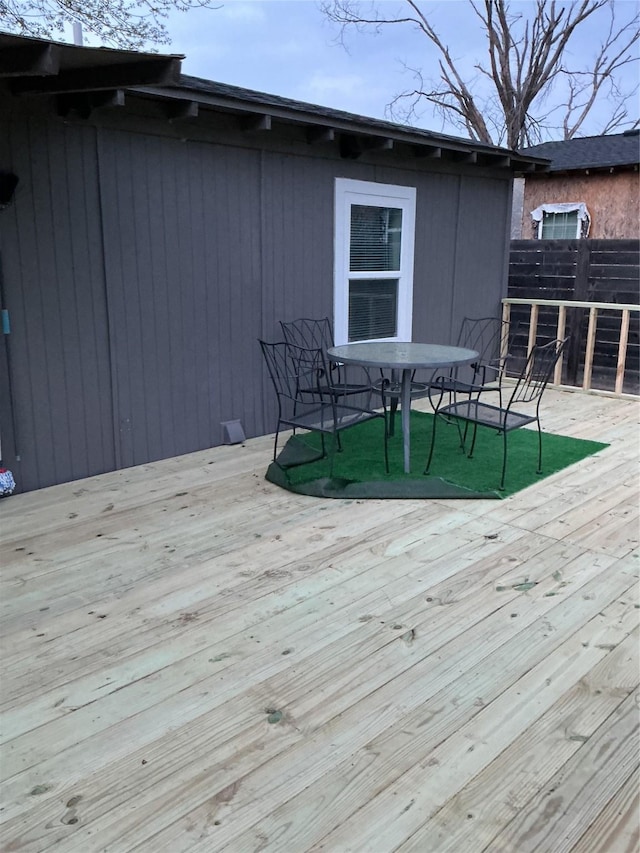 wooden terrace with outdoor dining space and fence private yard