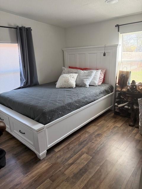 bedroom featuring dark wood finished floors
