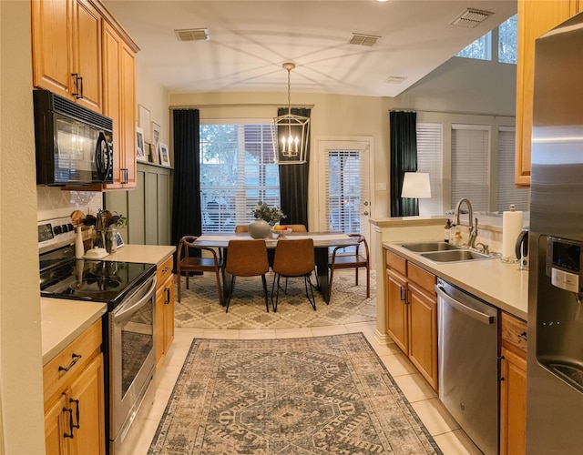 kitchen featuring a sink, stainless steel appliances, and visible vents